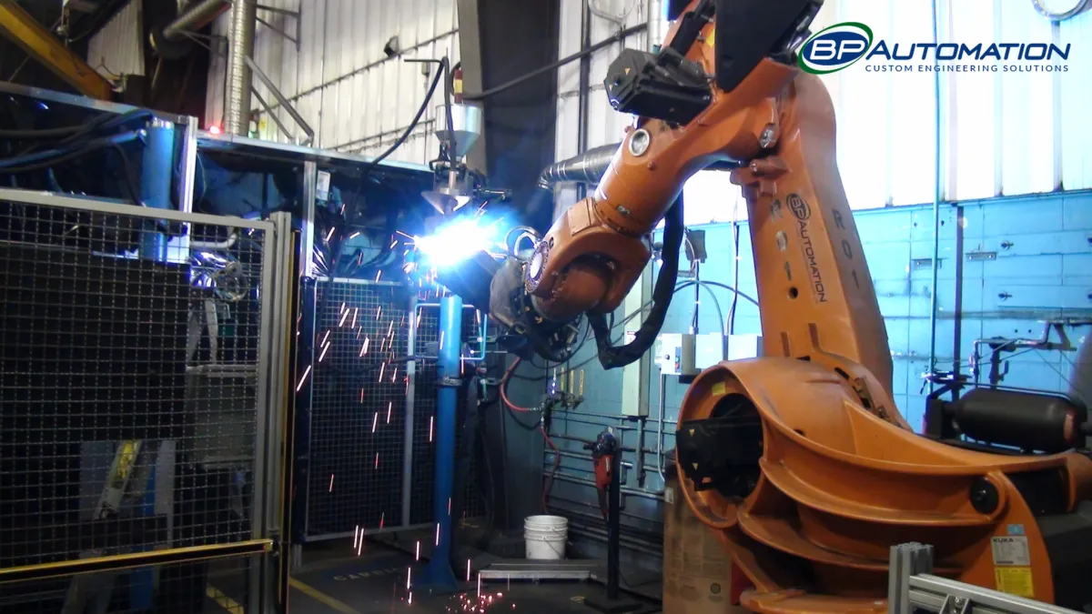 Industrial robotic welding cell in operation