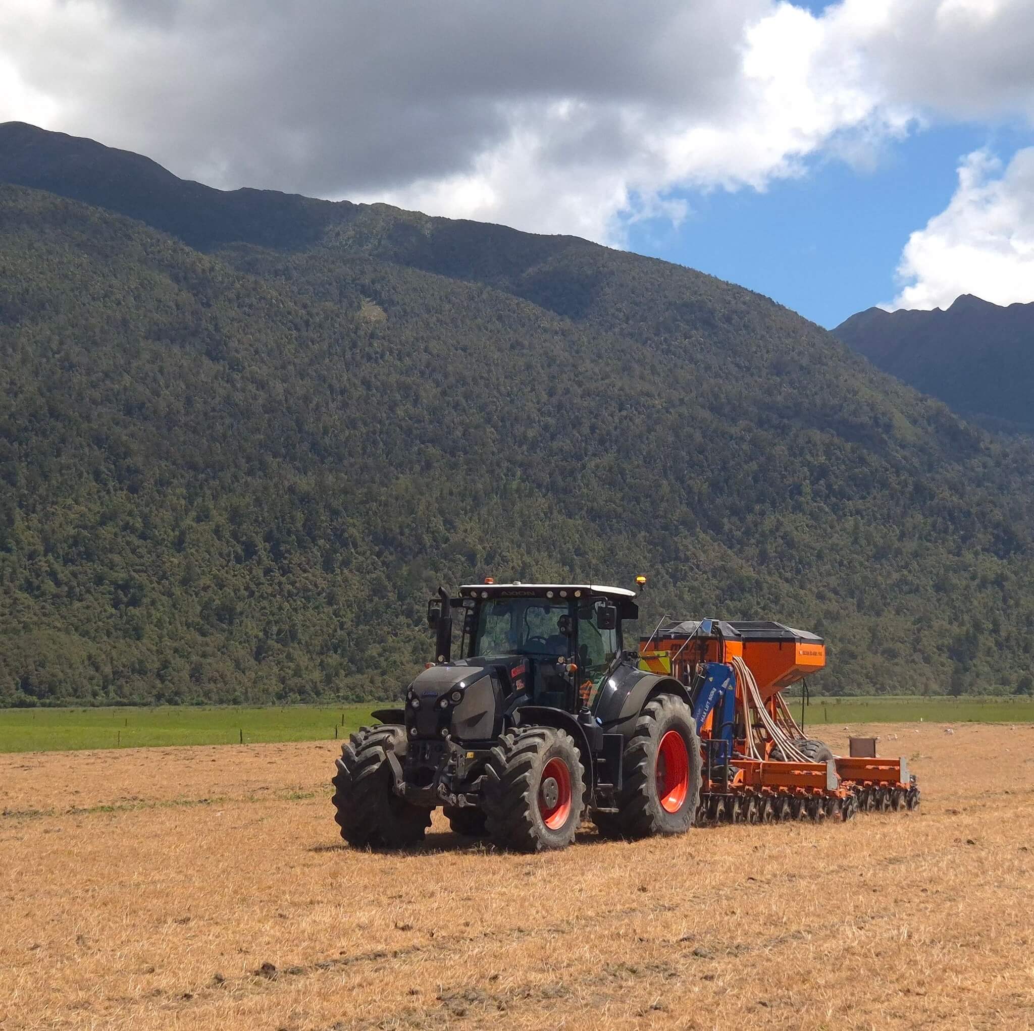 Pasture direct drilling machinery working in West Coast paddock