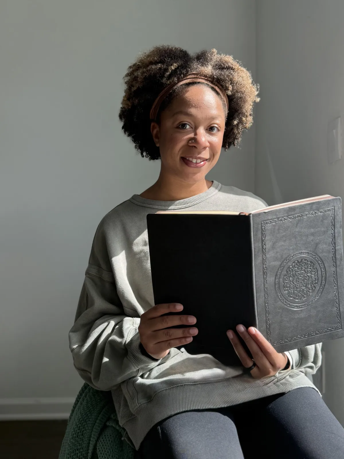 Woman happily reading as part of a quarterly book club subscription box