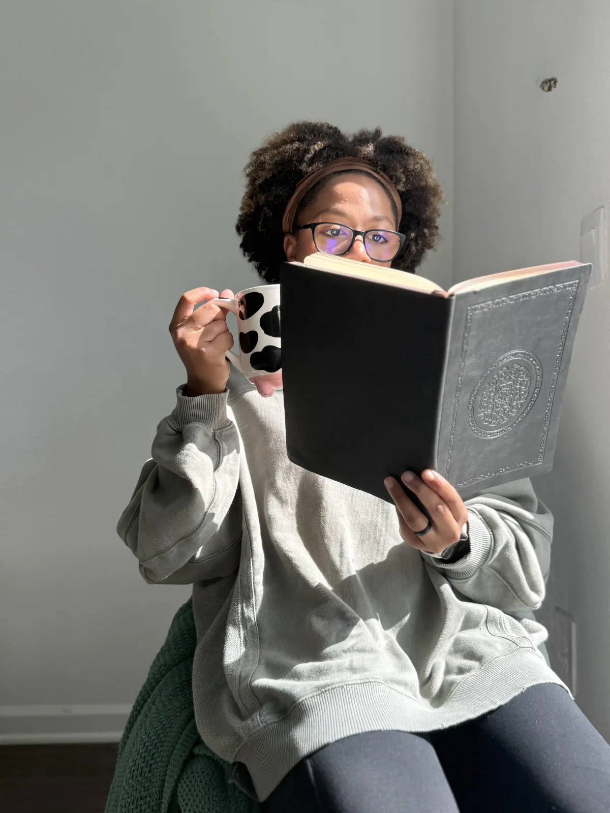 Woman reading at home as part of a book club subscription experience