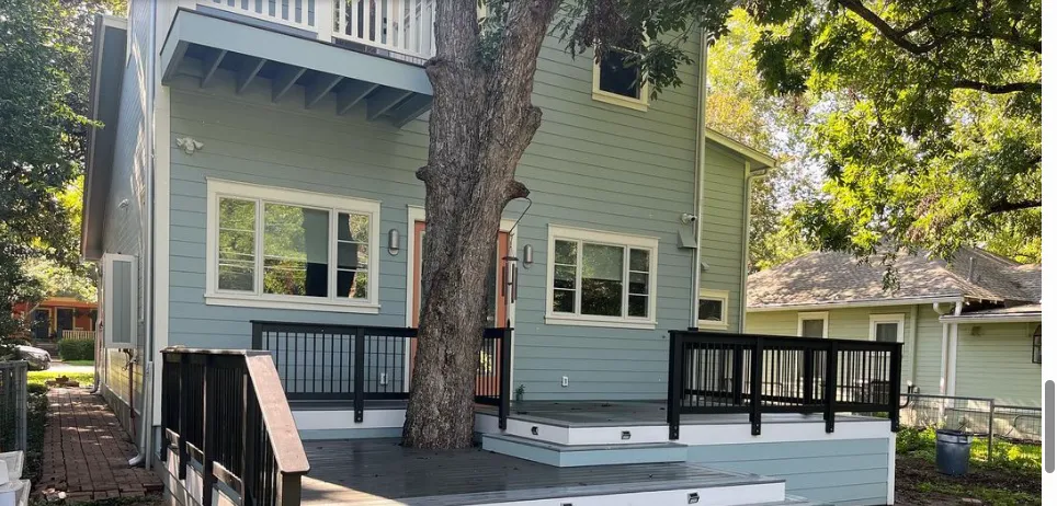 a kitchen with three stools and a center island