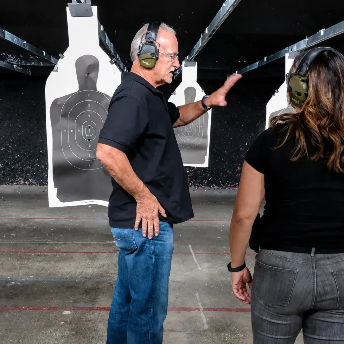 Instructor providing private handgun training to a student at an Arizona shooting range