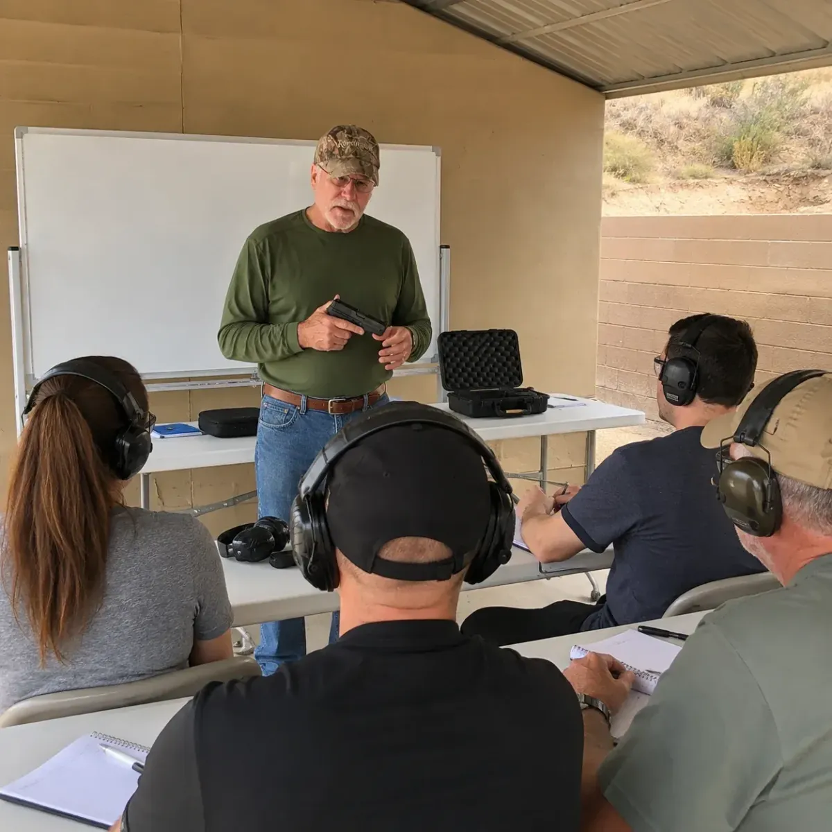 Adult students attending a professional NRA pistol training class