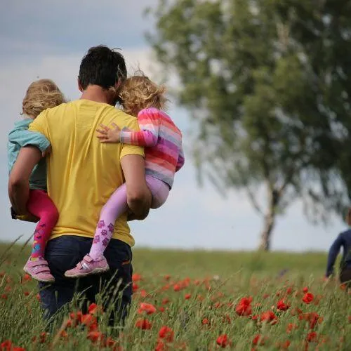 father holding his children