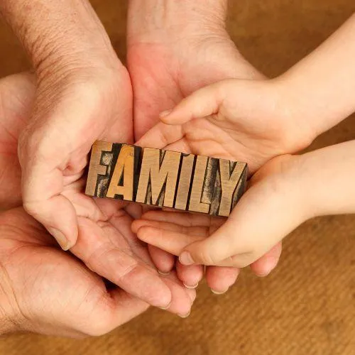 family holding a family sign after a happy family health insurance deal in Hoffman estates