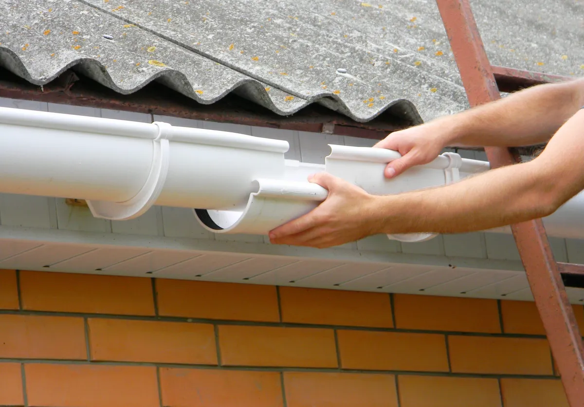 expert roofer installing the gutter