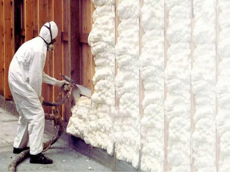 A & A Gutters insulation worker spraying foam insulation