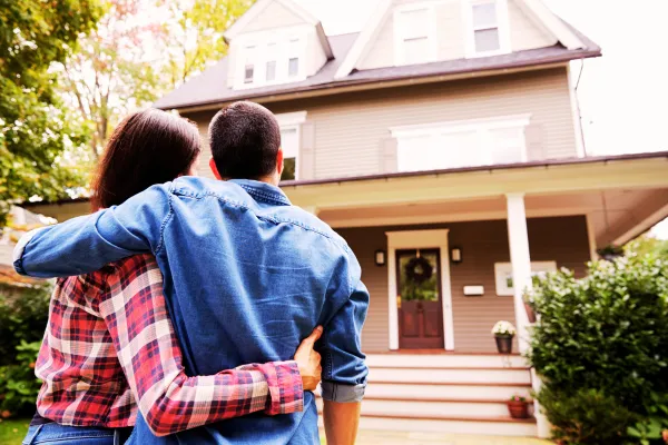 Happy couple enjoying their new gutters and insulation