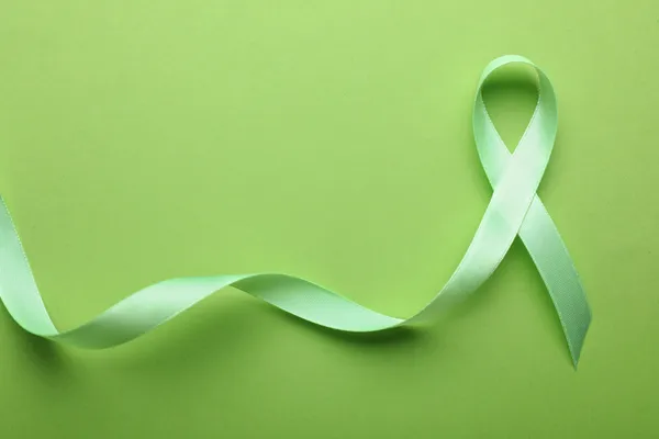 The green ribbon is a widely recognized symbol of mental health awareness and support. It represents hope, understanding, compassion, and the importance of breaking the stigma surrounding mental health.