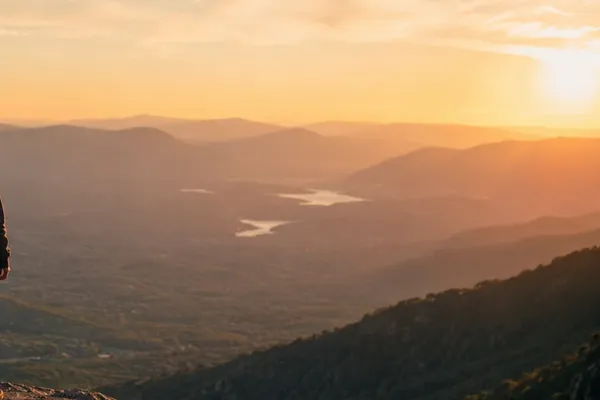 Vast open landscape overlooking mountains, with a wide horizon suggesting possibility, perspective and multiple directions forward.