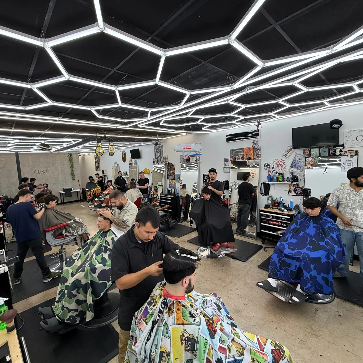 Barbers in a barbershop cutting clients