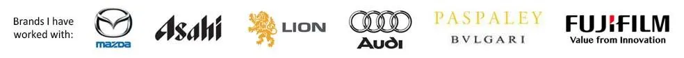 A banner displaying logos of brands Jean Kropper has worked with, including Mazda, Asahi, Lion, Audi, Paspaley, Bulgari, and Fujifilm.