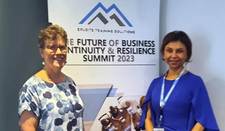 Jean Kropper at the 'Erudite Business Conference' in Sydney, NSW, standing with another attendee in front of a banner for 'The Future of Business Continuity & Resilience Summit 2023.