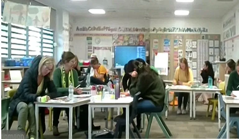 Teachers participating in an online workshop at Greenwich Public School, Greenwich, NSW, seated at classroom tables, engaging in a meditative drawing session.