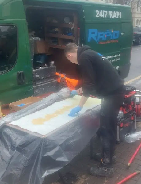 Plumber with customer n the kitchen