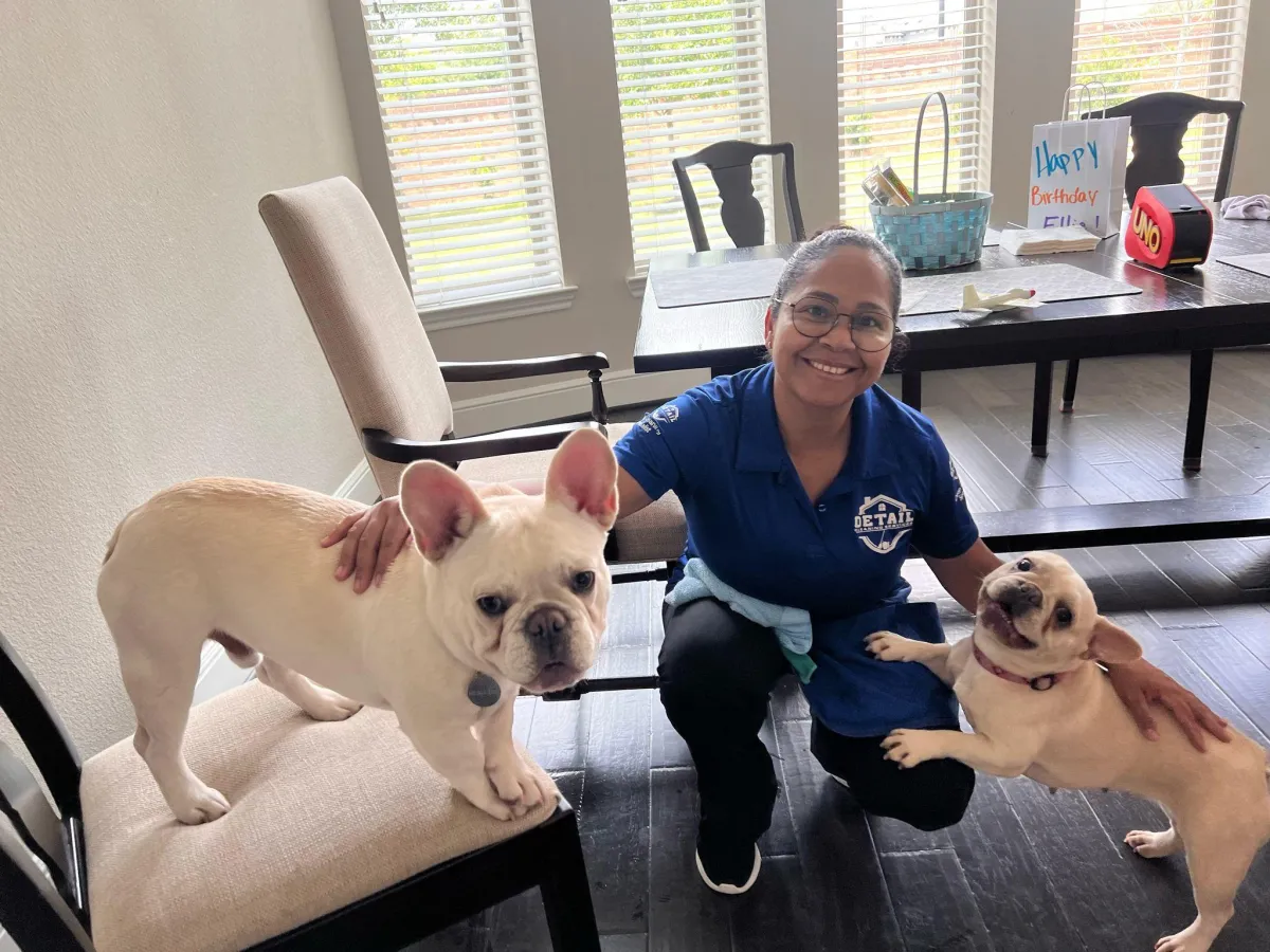 Cleaning professionals working warmly with a family