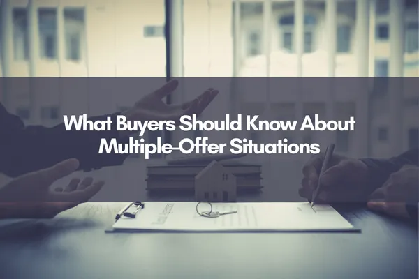 Real estate agent reviewing paperwork with buyers while discussing a multiple offer situation during a home purchase with title overlaid "What Buyers Should Know About Multiple-Offer Situations"