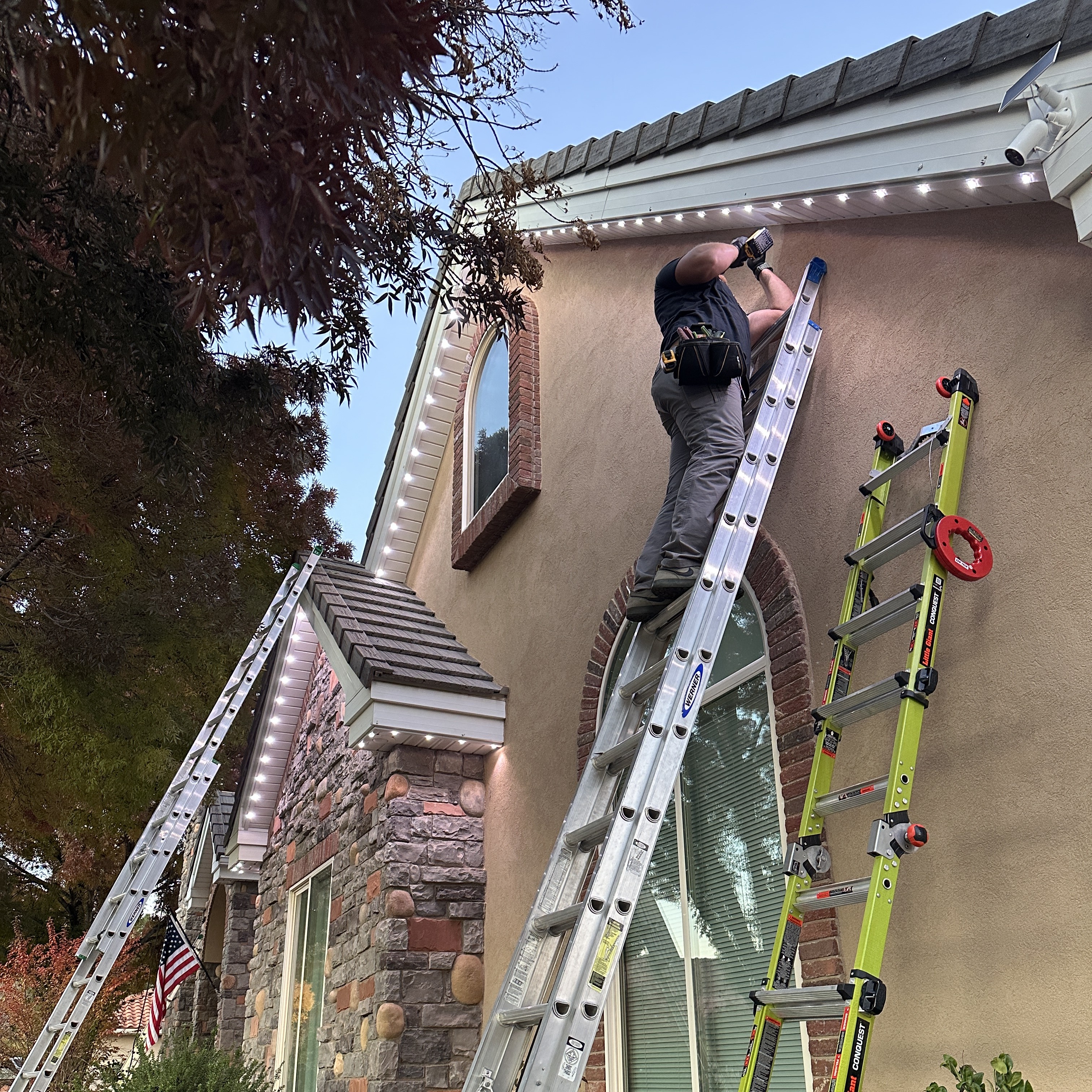 Professional permanent holiday lighting installation on a two-story home