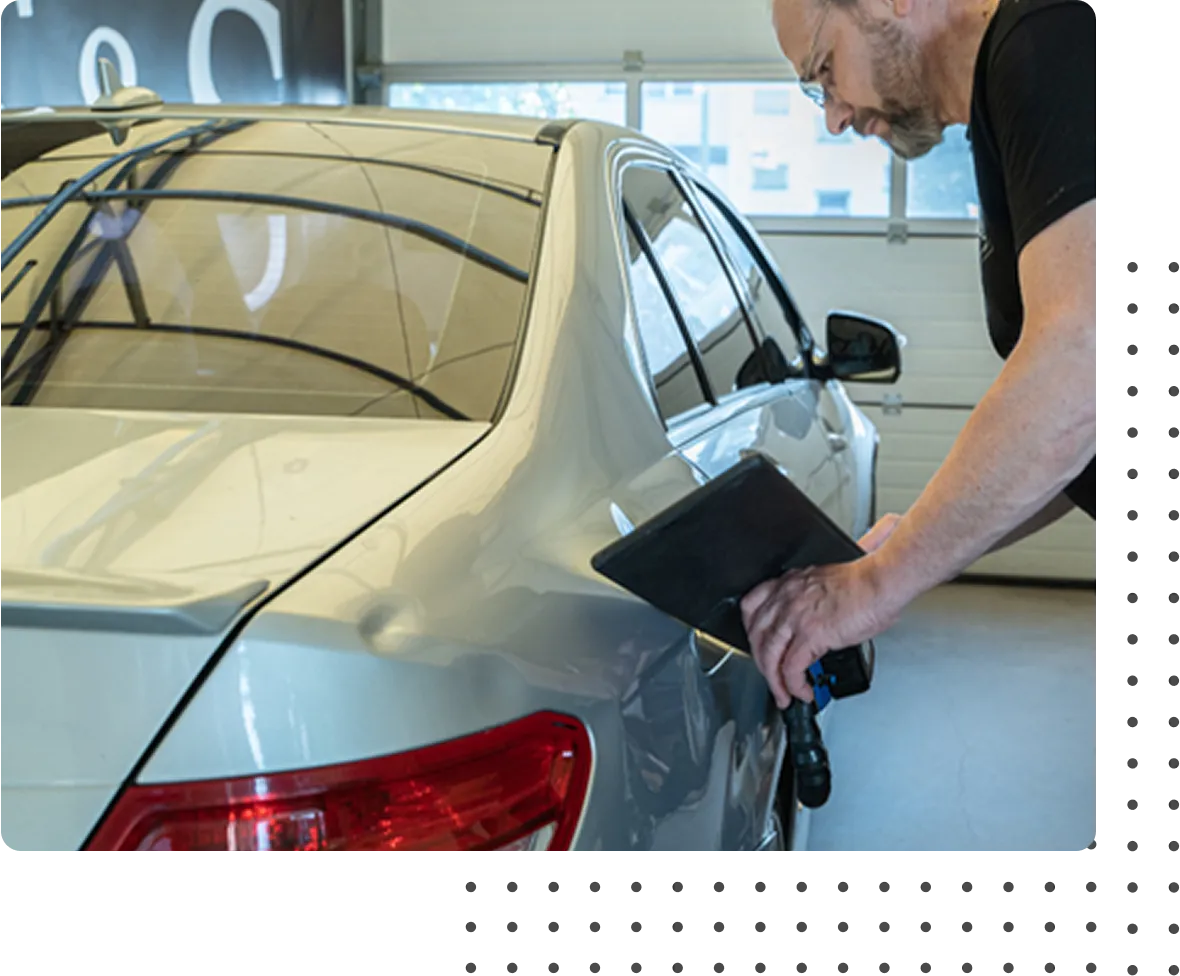 pdr technician repairing door dings