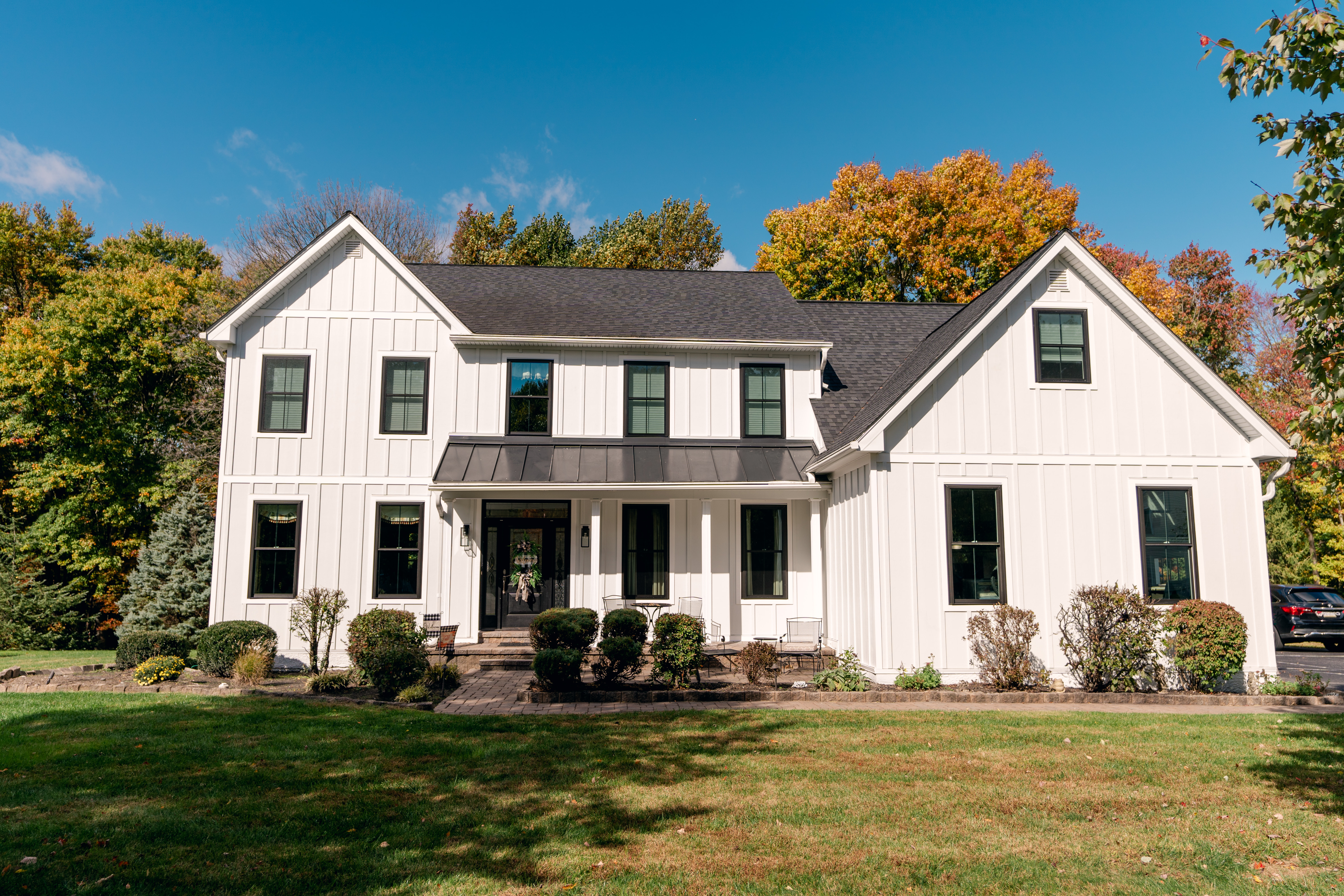 Home with white James Hardie siding and black windows
