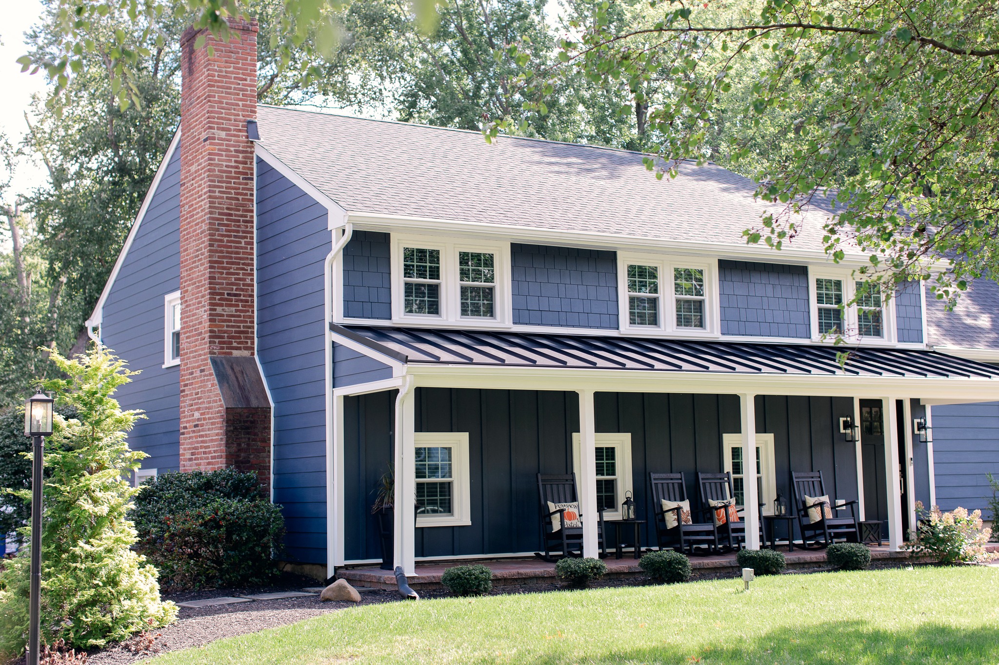 A bird sitting on top of a roof next to a building