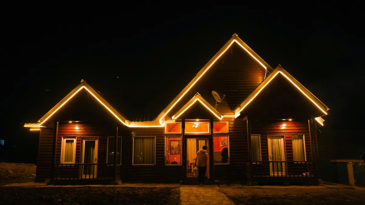 A lamp illuminates a dark, cozy corner.