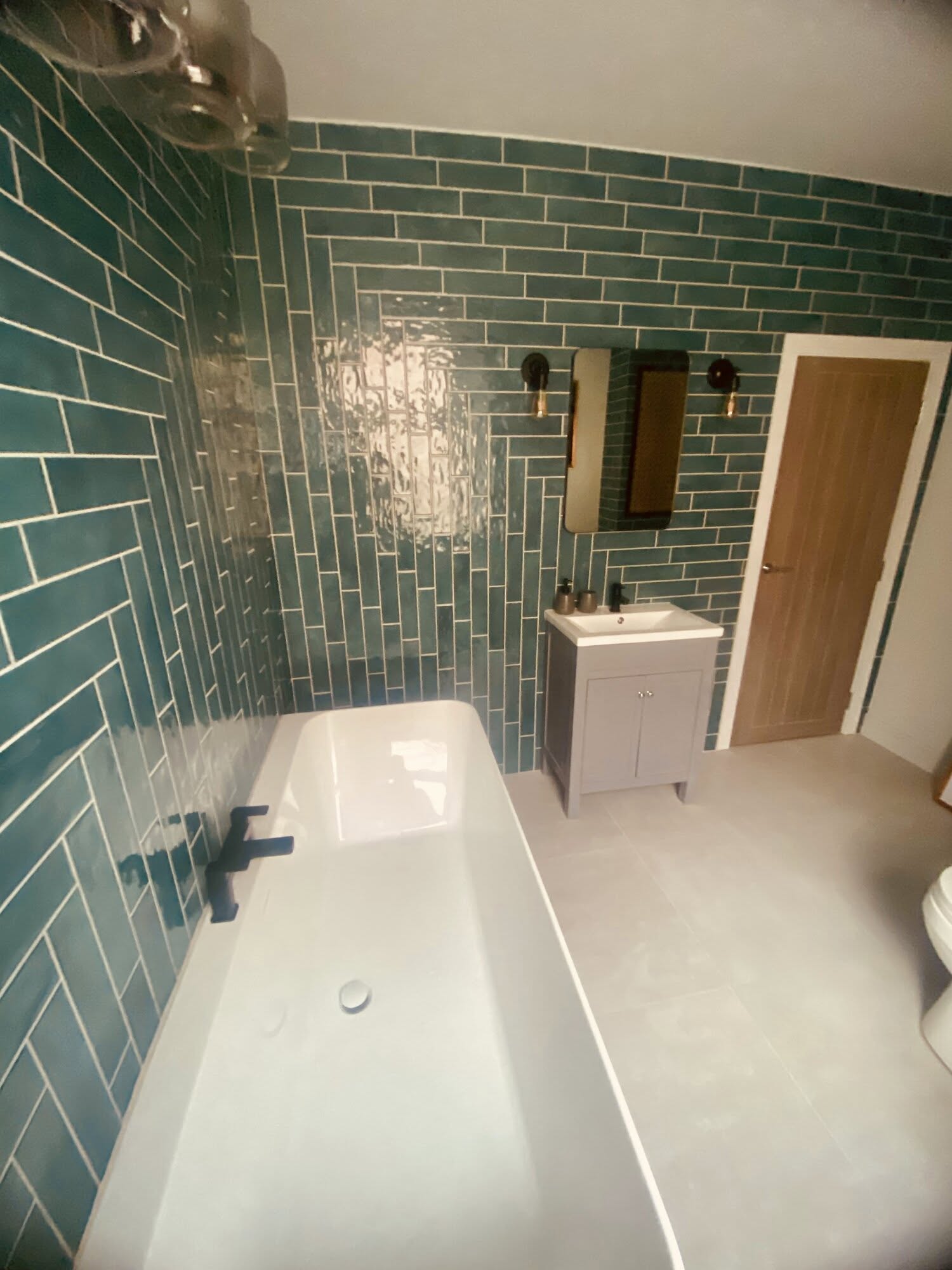 Full bathroom install with bath and herringbone tiling in green.jpg