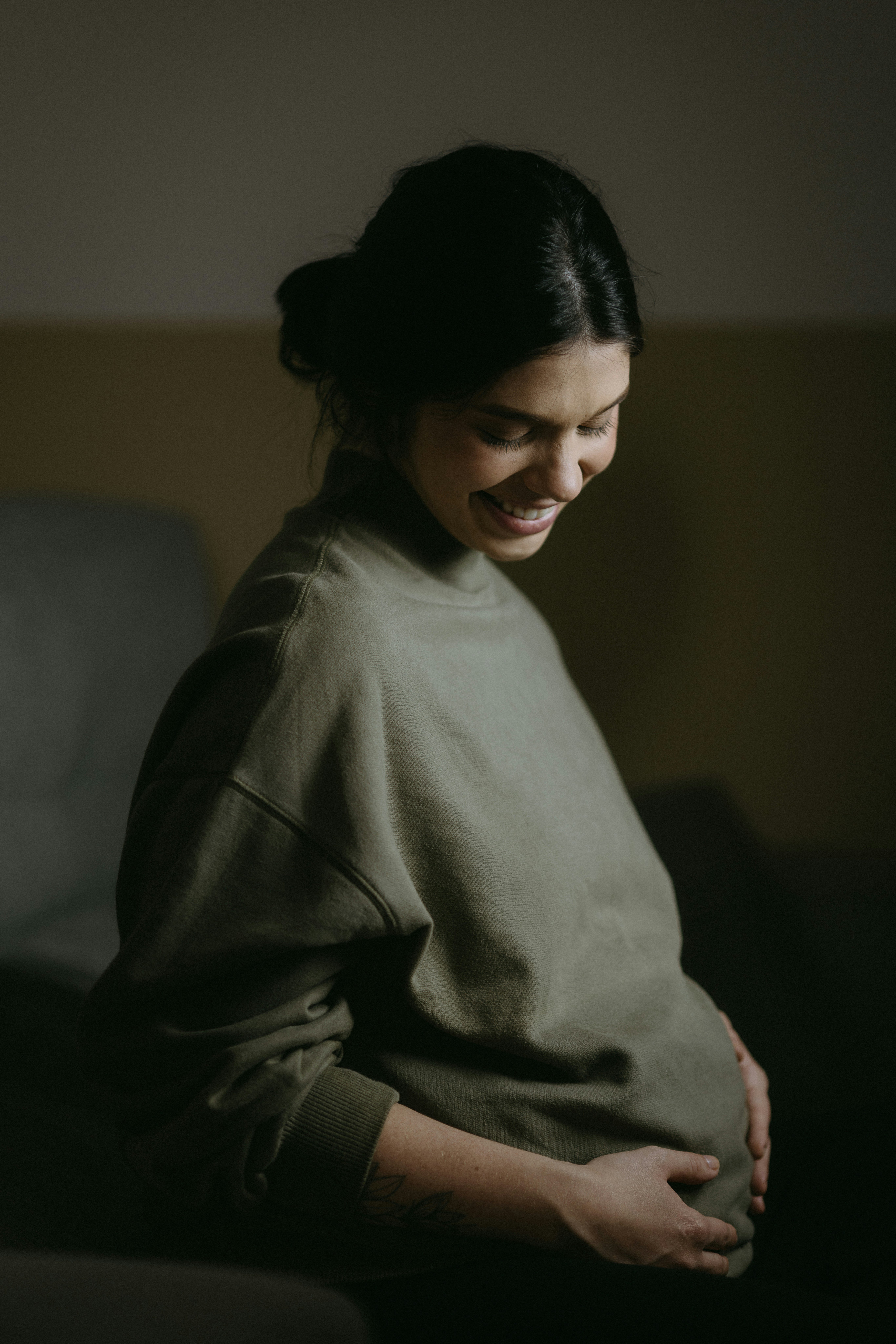 pregnant woman smiling at her belly