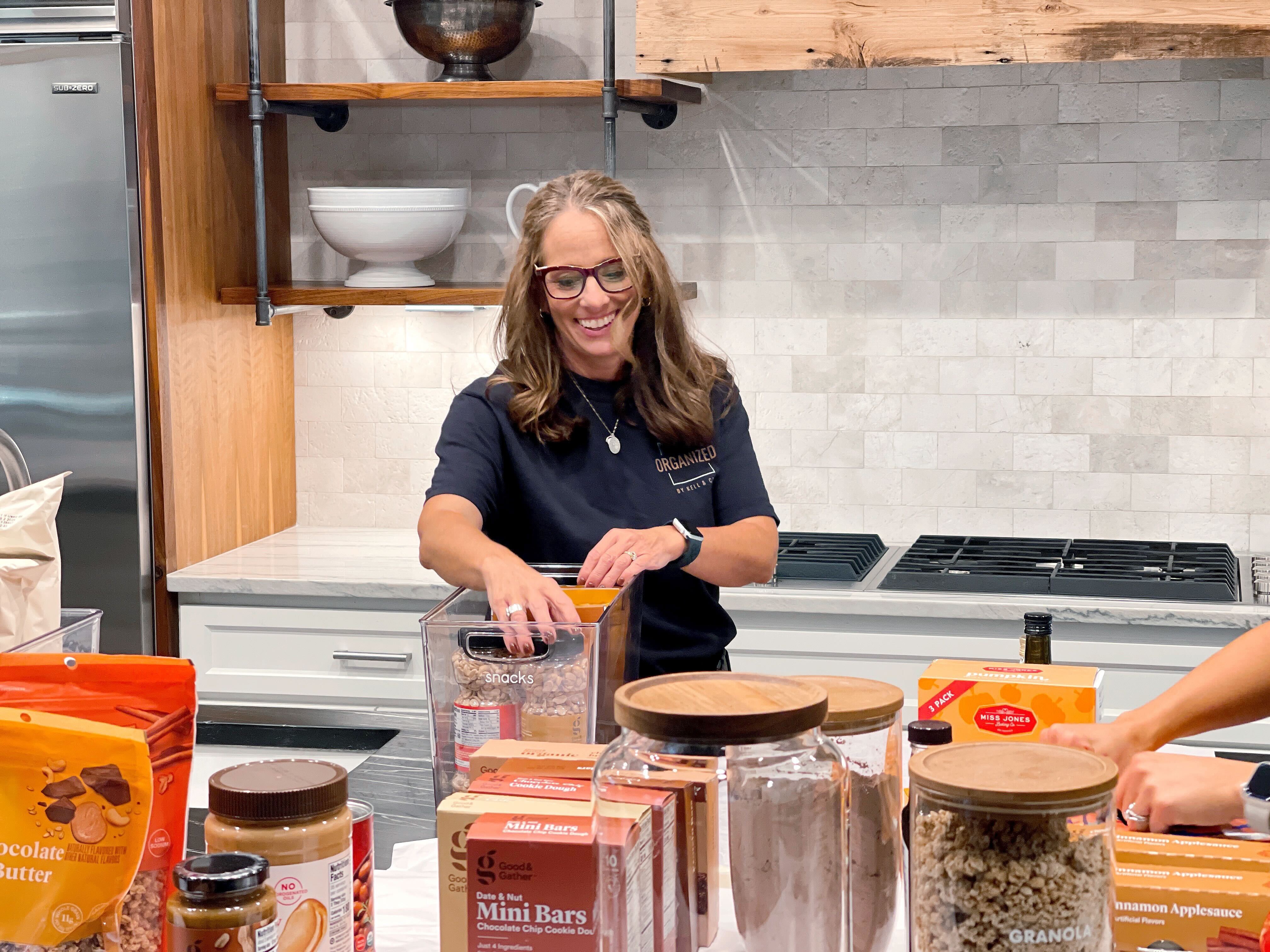 Professional organizer unpacking and organizing a kitchen