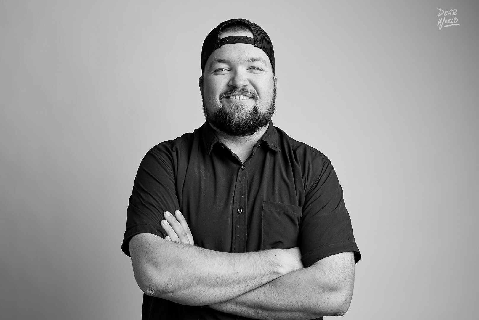 Portrait of a mid-30s male founder, gentle smile, navy-blue background, blazer, photorealistic editorial style