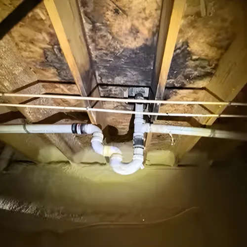 Close-up of a rusty white metal structure against blue sky
