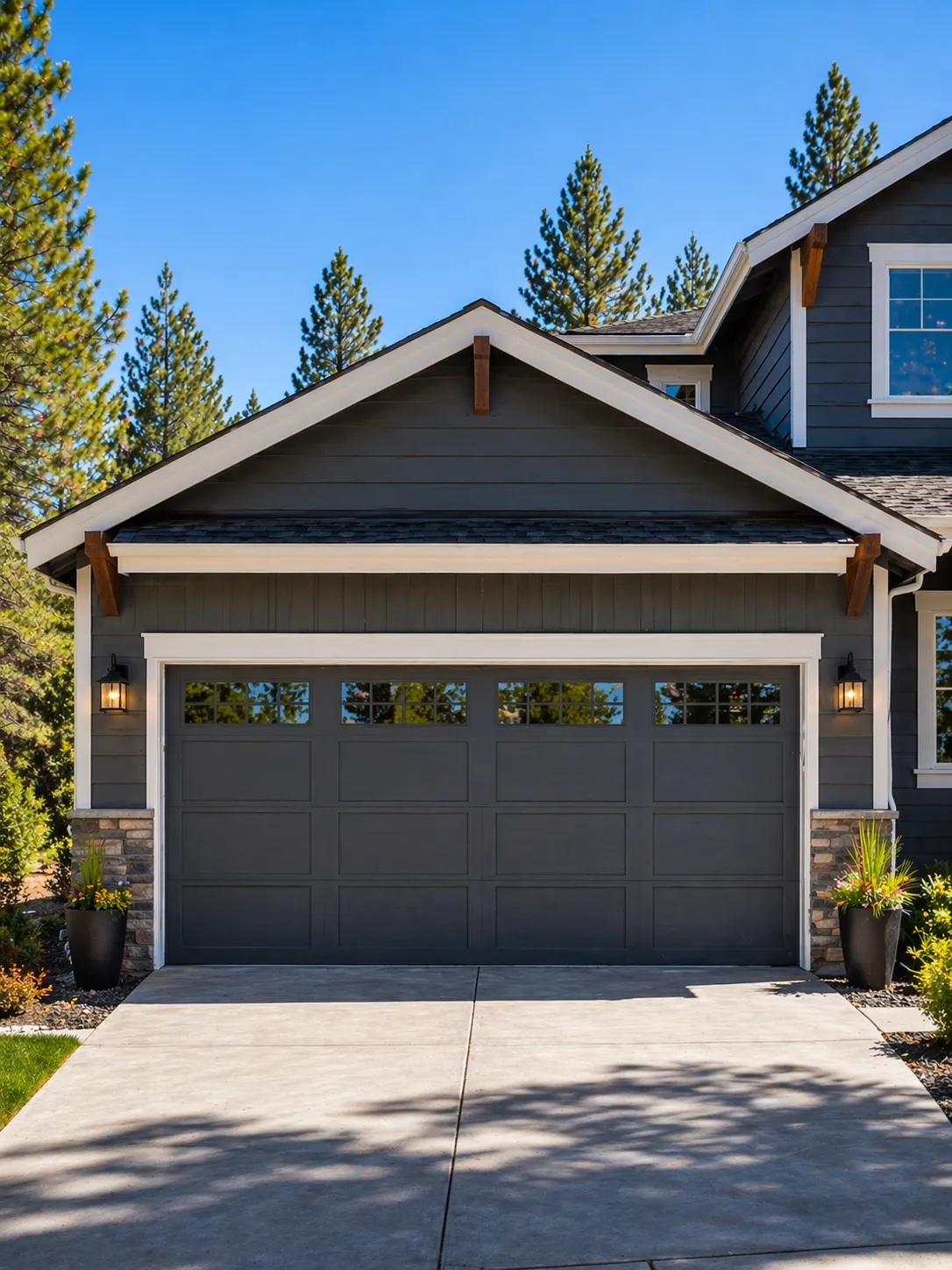 Garage door painting Bend Oregon: custom charcoal-grey craftsman garage door professionally painted with a smooth factory-grade finish, set against high desert pine trees.