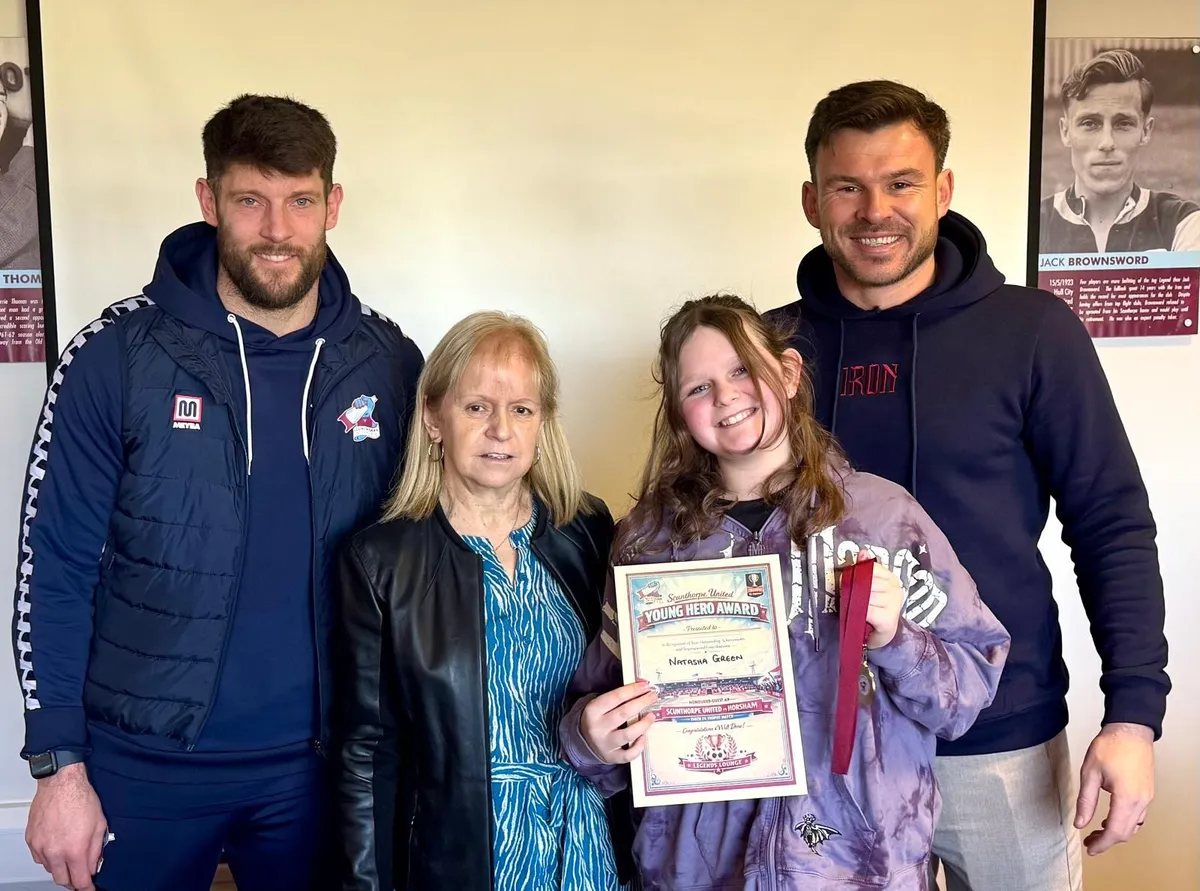 Natasha receiving recognition through the Scunthorpe United Young Hero Award