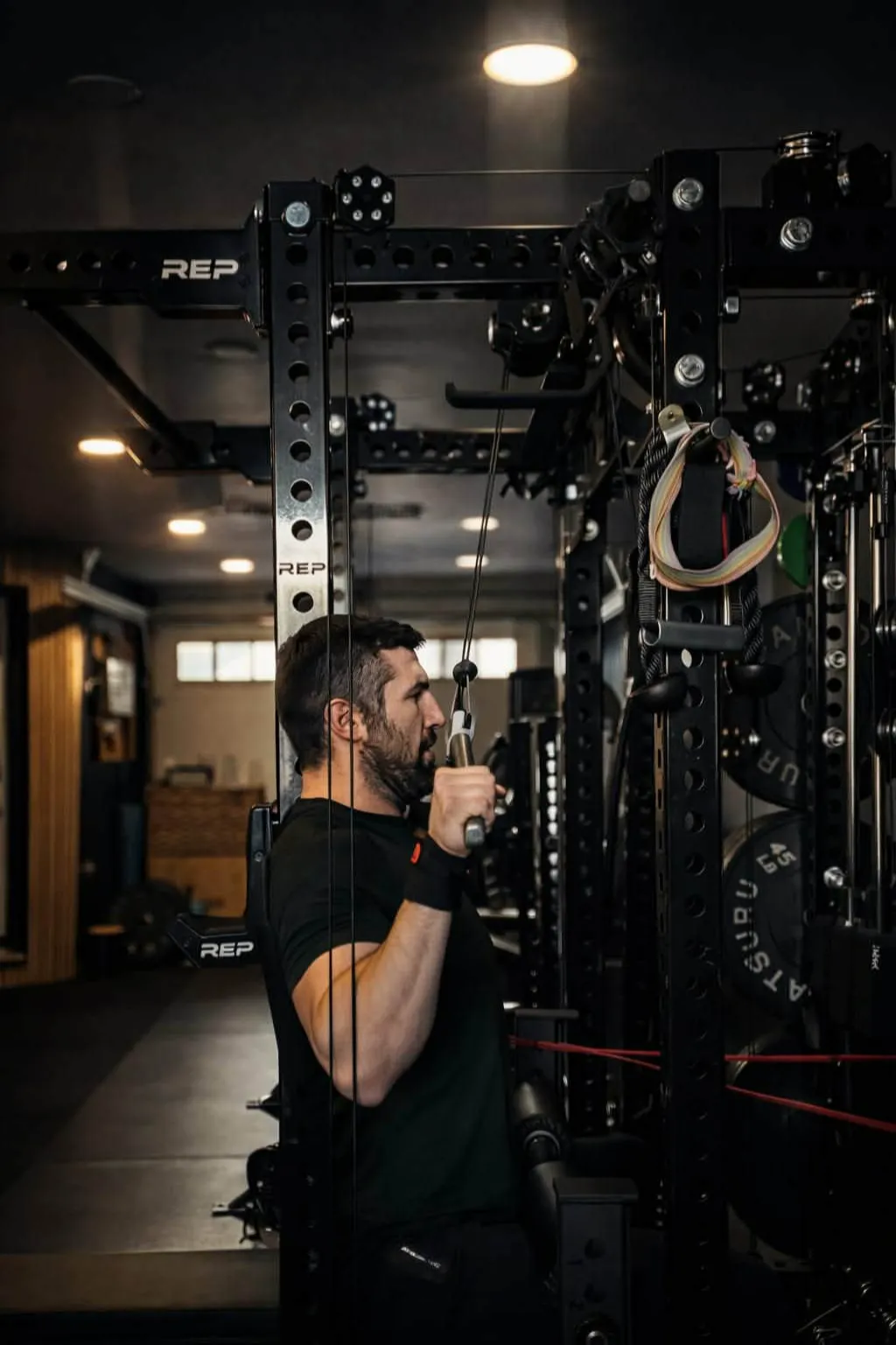 This is an image of our head coach Ethan Tripp training a client using a rowing machine