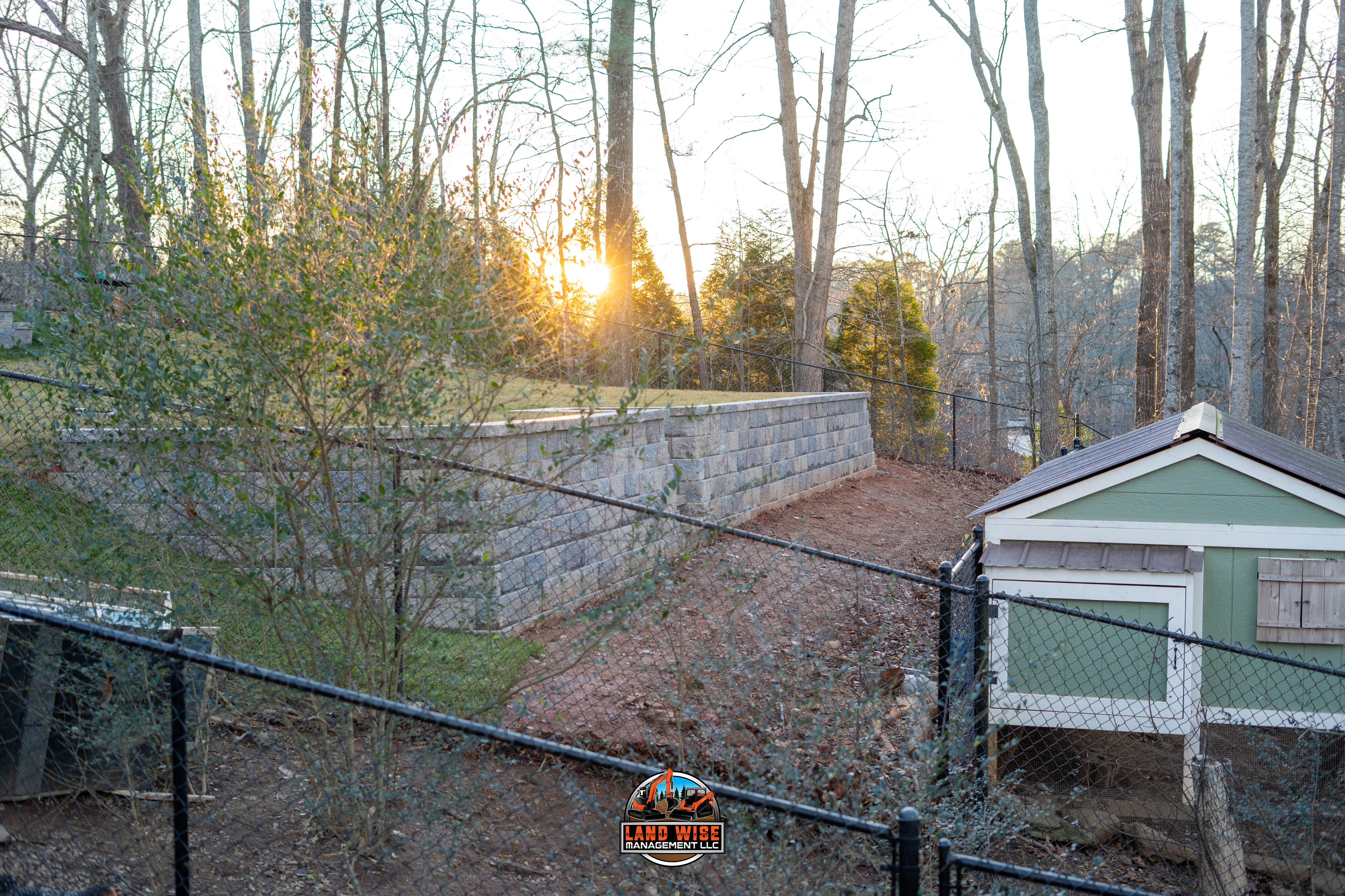 Modern buildings line a calm blue river with boats.