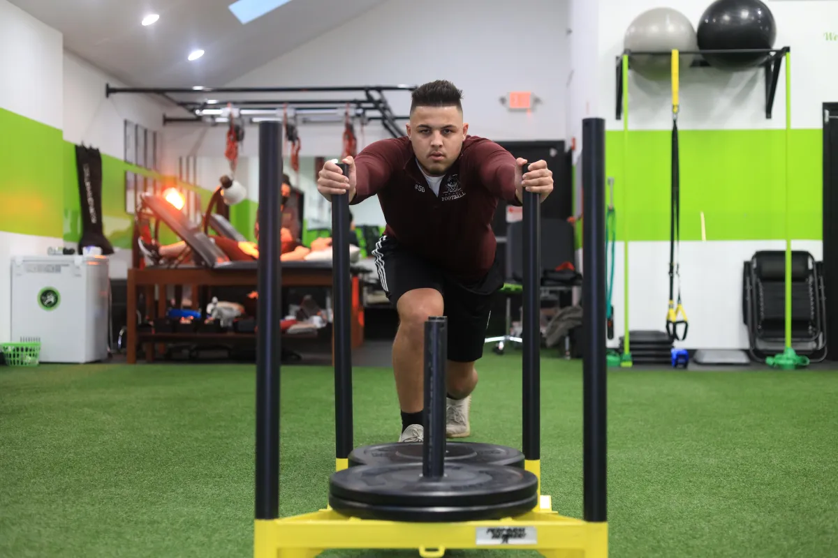 Athlete pushing sled