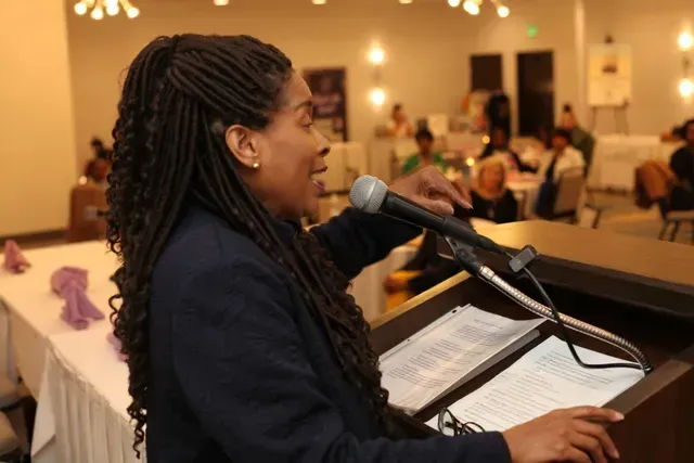 Alesia B. Jackson speaking at a wellness event
