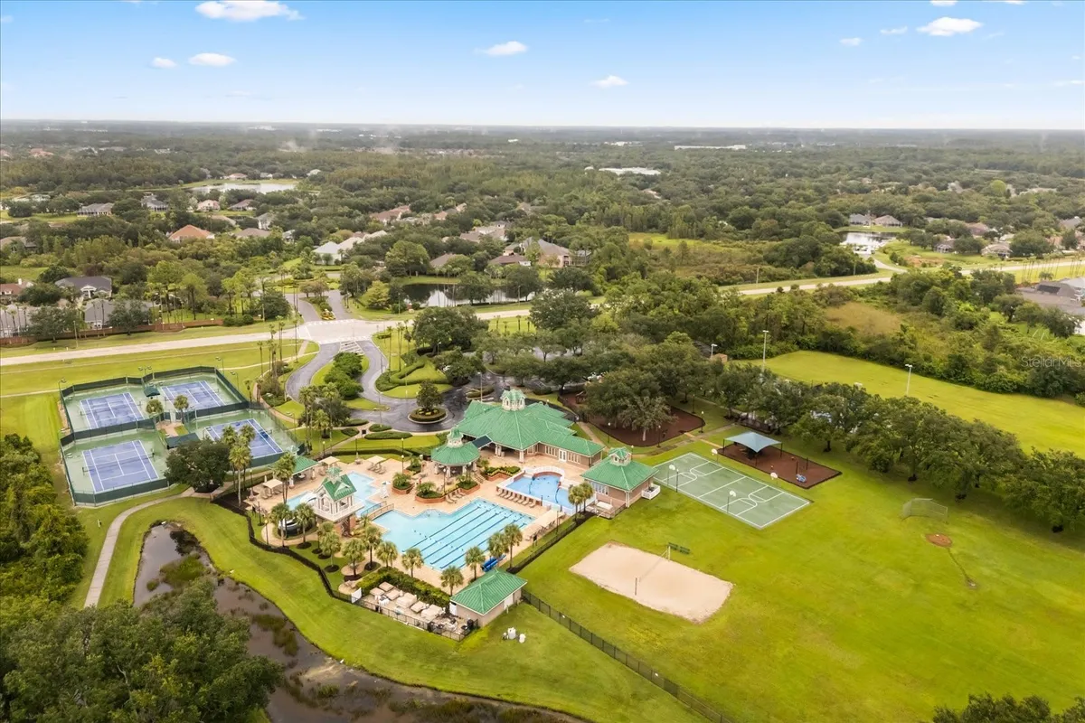 Aerial listing photograph of West Meadows’ community recreation center. The listing also includes a separate private pool at the home.