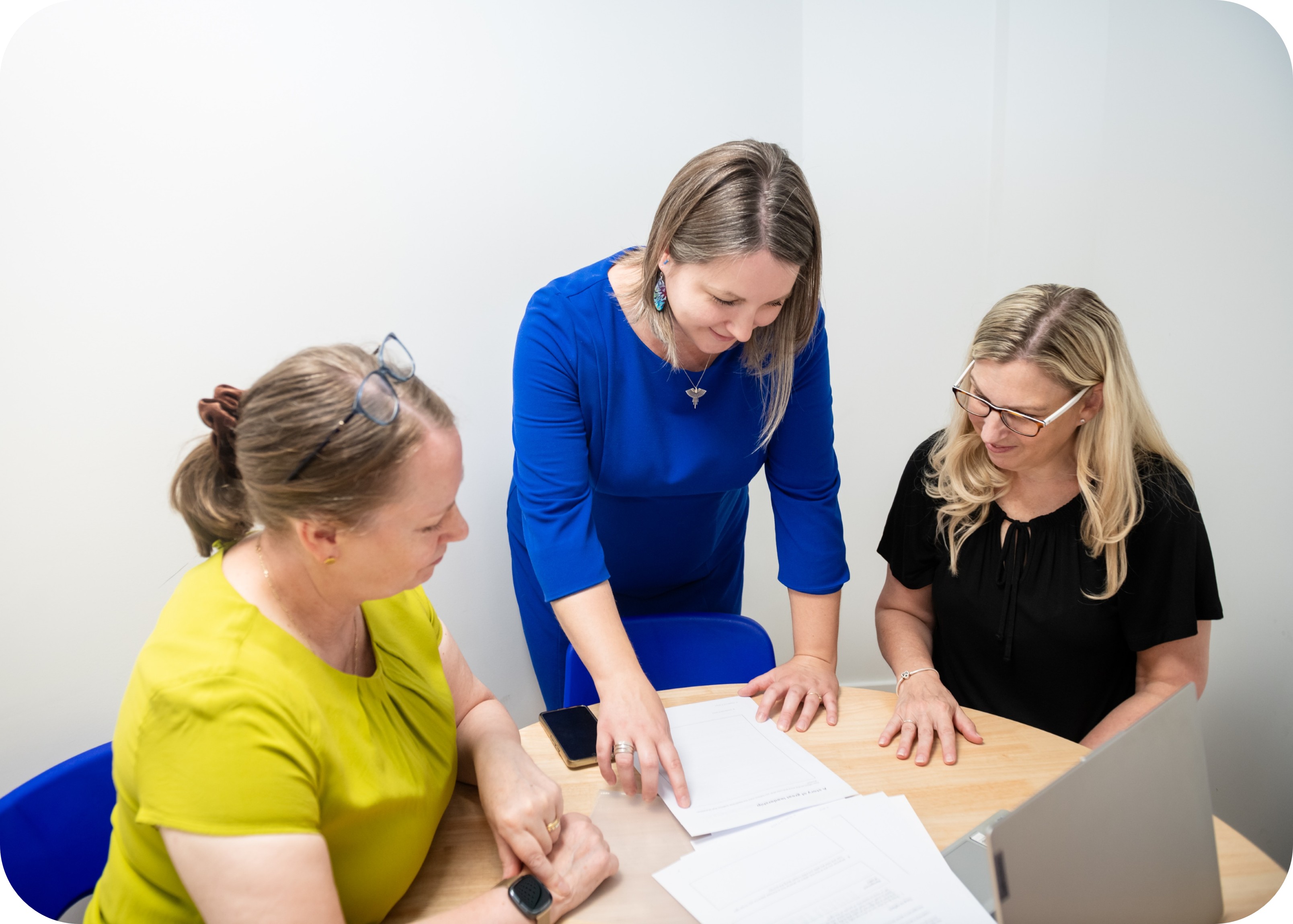 Karen, Georgie and Natalie looking at documents