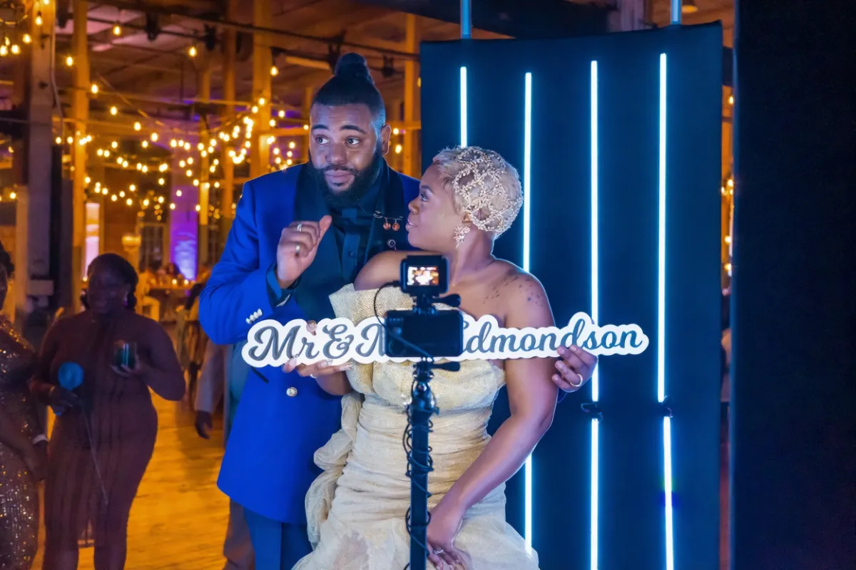 Couple standing on a 360 platform, dancing inside an LED enclosure while the 36 arm spin with a dslr camera attached in Tampa, Florida