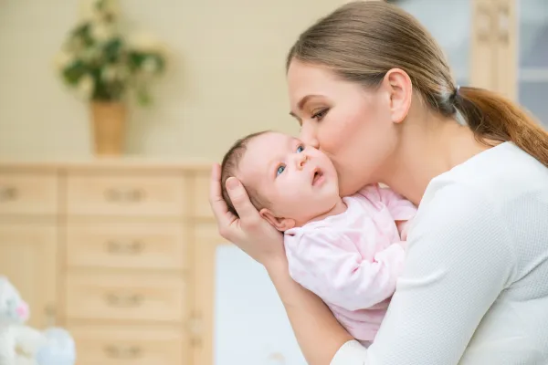 Baby sleeping peacefully in cot — gentle sleep support for 4 to 12 month olds