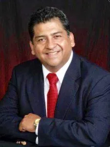 a silhouette of a man pointing at the sun