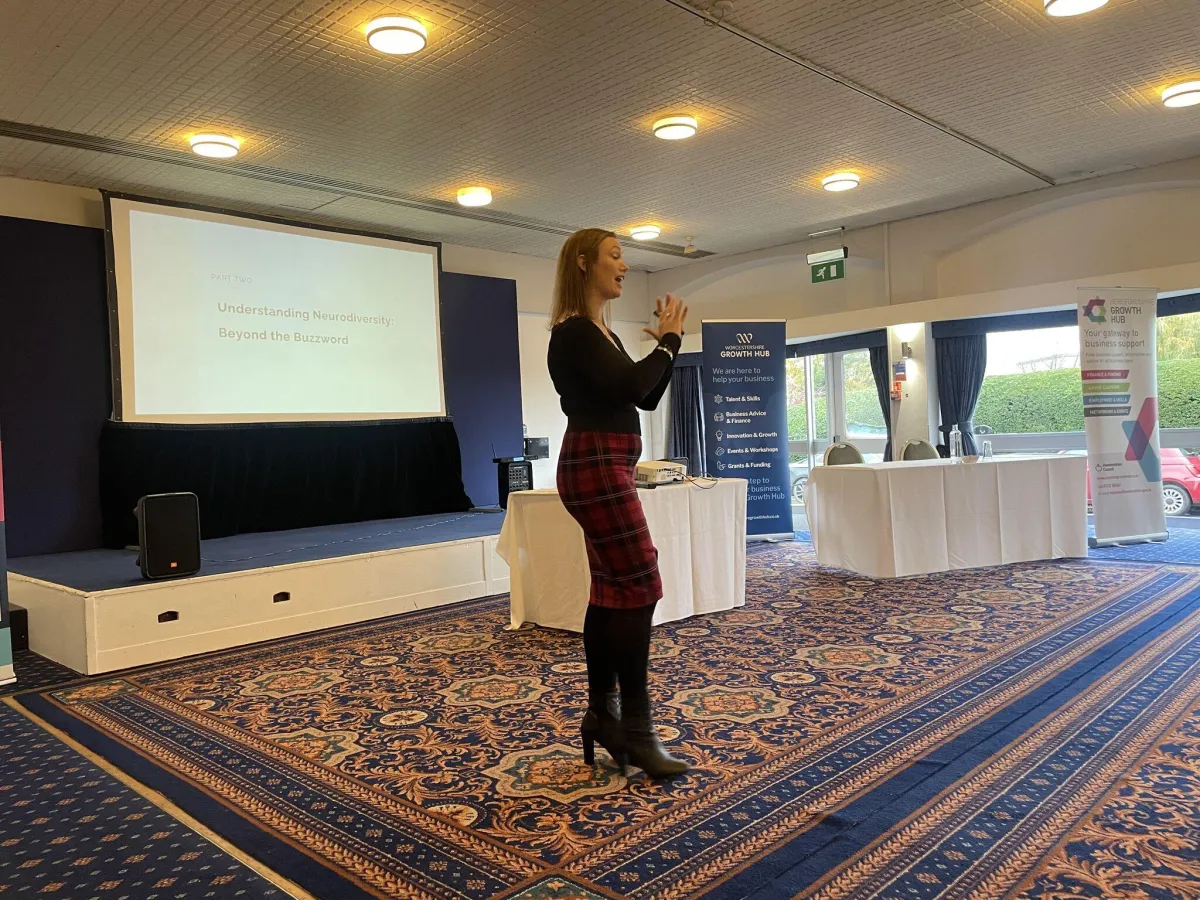 Maisie Cass delivering a keynote on neurodiversity in business settings.