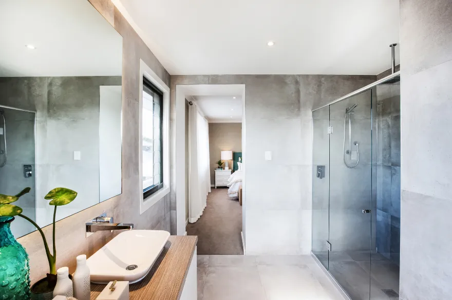 comfort room with white bathtub and brown wooden cabinets