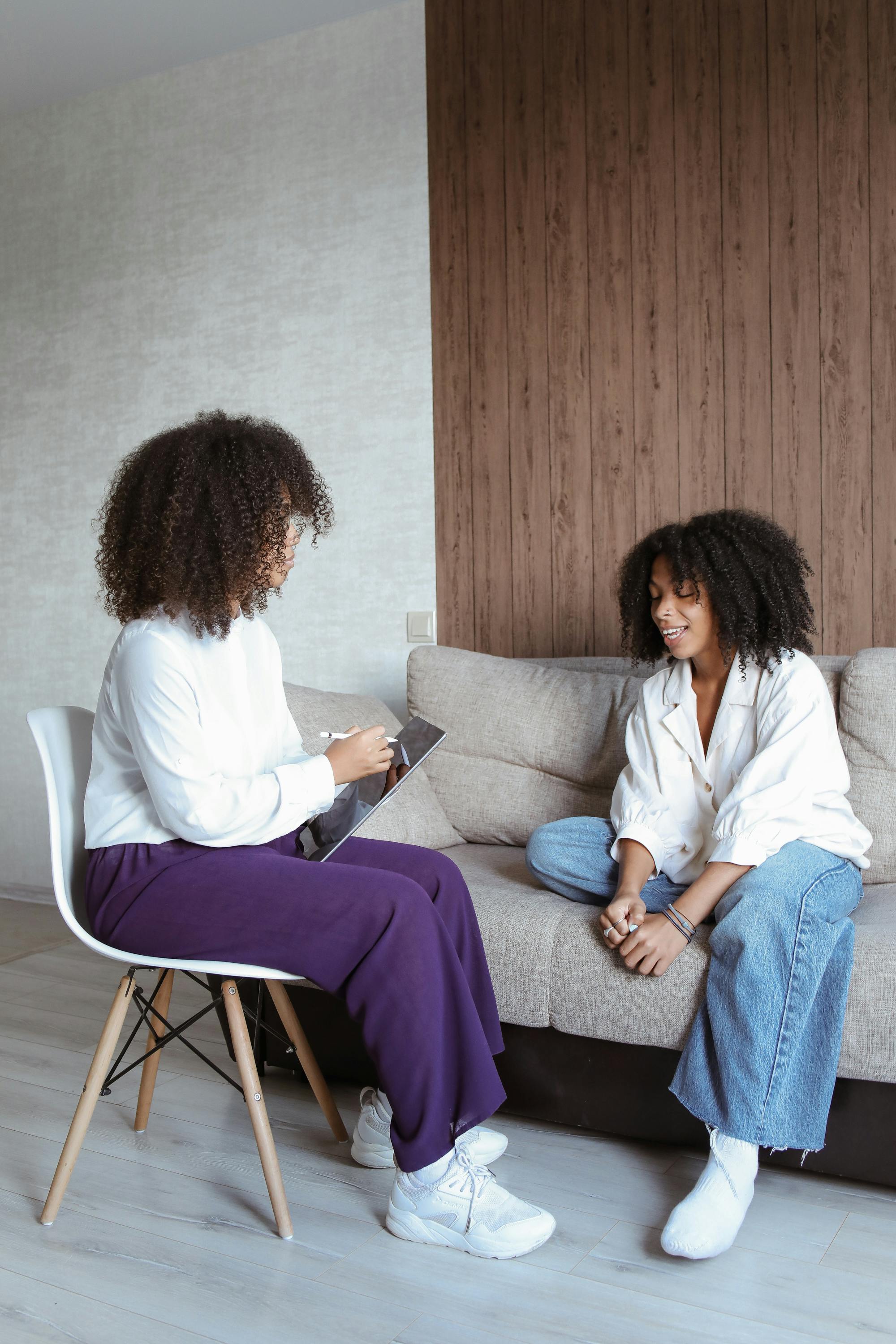 Nurse practitioner in a calm clinical setting having a reassuring conversation with a patient, conveying safety and personalized functional medicine care.