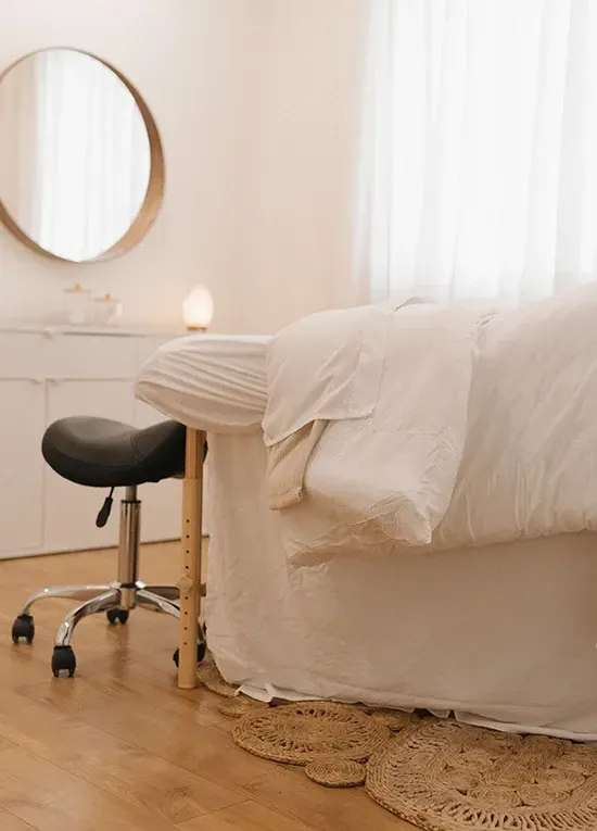 Portrait of the clinic founder in a softly lit treatment suite, professional and approachable.