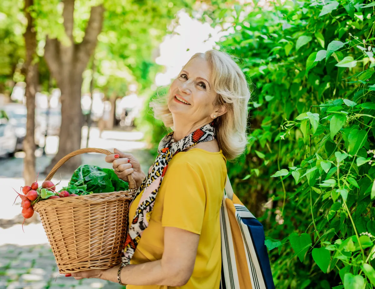 Healthy woman holding basket of veggies