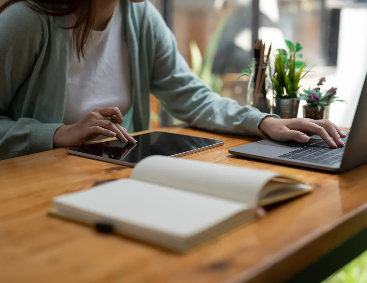 woman working on laptop and tablet