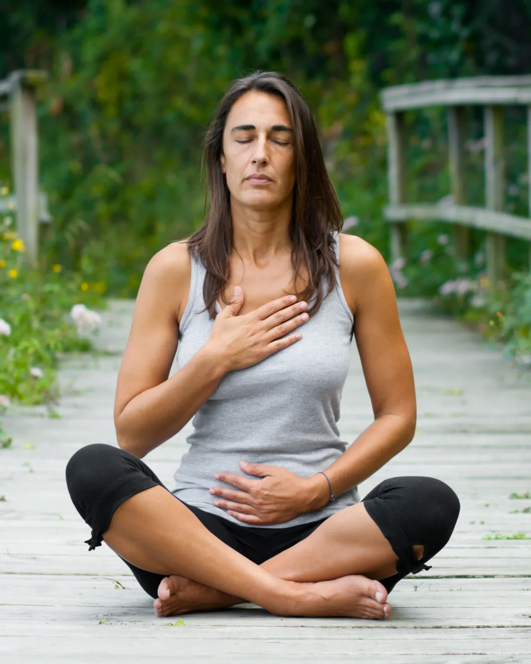 A thoughtful, elegant woman in soft warm light, reflecting on her vitality journey.
