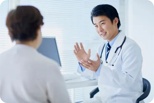 A doctor in a white coat consulting with a patient in an office